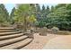 Charming backyard retreat with stone fire pit, patio, and lush landscaping, perfect for relaxing and entertaining at 104 Hidden Springs Ln, Peachtree City, GA 30269