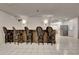 Finished basement wet bar with bar-height seating, tile floors and a view to the kitchen at 104 Hidden Springs Ln, Peachtree City, GA 30269