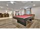 Spacious basement area with a pool table, bar, and ample seating for entertainment at 104 Hidden Springs Ln, Peachtree City, GA 30269