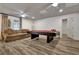Basement recreation area featuring a pool table and a comfortable seating area with an adjacent doorway at 104 Hidden Springs Ln, Peachtree City, GA 30269