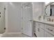 Bathroom featuring single vanity with marble counters, stainless steel fixtures, and door to shower at 104 Hidden Springs Ln, Peachtree City, GA 30269