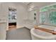 Bright bathroom featuring a standalone tub and marble vanity near an open bedroom at 104 Hidden Springs Ln, Peachtree City, GA 30269