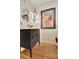 Stylish half-bath with a modern vanity, granite counter and ornate mirror at 104 Hidden Springs Ln, Peachtree City, GA 30269