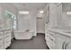 Bright bathroom features a standalone tub, shuttered windows, and elegant lighting at 104 Hidden Springs Ln, Peachtree City, GA 30269