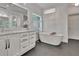 Luxurious bathroom showcasing a standalone tub with stylish fixtures and marble counters at 104 Hidden Springs Ln, Peachtree City, GA 30269