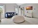 View of bedroom showcasing seating area, entertainment center, and windows at 104 Hidden Springs Ln, Peachtree City, GA 30269