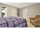 Bedroom with a view of the bathroom and a cozy seating area with an armchair at 104 Hidden Springs Ln, Peachtree City, GA 30269