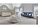 Bright bedroom featuring a cozy seating area, bed with storage, and natural light at 104 Hidden Springs Ln, Peachtree City, GA 30269