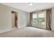 Bedroom with large windows letting in natural light and curtains at 104 Hidden Springs Ln, Peachtree City, GA 30269