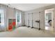 Spacious walk-in closet with natural light, two clothing racks, and colorful cube shelving at 104 Hidden Springs Ln, Peachtree City, GA 30269