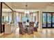 Elegant dining room with hardwood floors, chandelier, and bay window overlooking the yard at 104 Hidden Springs Ln, Peachtree City, GA 30269
