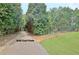 Driveway with landscaping and a golf cart path at 104 Hidden Springs Ln, Peachtree City, GA 30269