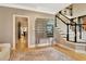 Hallway featuring hardwood floors, staircase, and a unique decorative cabinet, creating a stylish and functional space at 104 Hidden Springs Ln, Peachtree City, GA 30269