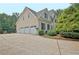 Spacious three-car garage with a long driveway and mature landscaping at 104 Hidden Springs Ln, Peachtree City, GA 30269