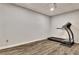 Finished basement gym featuring a treadmill and wood-look flooring at 104 Hidden Springs Ln, Peachtree City, GA 30269