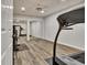Finished basement gym featuring mirrored closet doors and wood-look flooring at 104 Hidden Springs Ln, Peachtree City, GA 30269