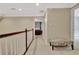 Hallway with white wainscoting and trim, and an upholstered bench seat at 104 Hidden Springs Ln, Peachtree City, GA 30269