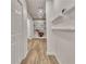 Finished basement hallway features white shelving, wood-look floors, and white trim at 104 Hidden Springs Ln, Peachtree City, GA 30269