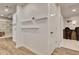 Finished basement hallway with white shelving, wood-look floors, white trim and white doors at 104 Hidden Springs Ln, Peachtree City, GA 30269