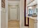 Hallway with white door, crown moulding and chandelier in the distance at 104 Hidden Springs Ln, Peachtree City, GA 30269