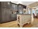 Kitchen features stainless appliances, custom cabinets and an island with seating at 104 Hidden Springs Ln, Peachtree City, GA 30269