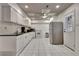 Well-lit kitchen featuring white appliances and cabinetry and tile flooring at 104 Hidden Springs Ln, Peachtree City, GA 30269