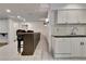 Kitchen area with bar seating, white cabinets, and white tile flooring at 104 Hidden Springs Ln, Peachtree City, GA 30269