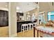 Eat-in kitchen features granite counters, stainless appliances, and breakfast bar with white stools at 104 Hidden Springs Ln, Peachtree City, GA 30269