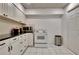 Bright kitchen featuring white cabinets and appliances and black countertops at 104 Hidden Springs Ln, Peachtree City, GA 30269