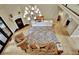 Living room with chandelier, fireplace, hardwood floors and nice furnishings at 104 Hidden Springs Ln, Peachtree City, GA 30269