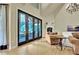 Bright living room featuring vaulted ceilings, a fireplace, and glass doors to the outside porch at 104 Hidden Springs Ln, Peachtree City, GA 30269