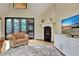 Cozy living room with fireplace, large windows, and comfortable seating, perfect for relaxing and entertaining guests at 104 Hidden Springs Ln, Peachtree City, GA 30269