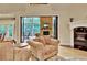 Stylish living room featuring comfortable seating, a fireplace, and seamless transition to the outdoors, perfect for entertaining at 104 Hidden Springs Ln, Peachtree City, GA 30269