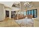 Open concept living room with hardwood floors, a decorative chandelier and an attached kitchen at 104 Hidden Springs Ln, Peachtree City, GA 30269