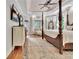 Spacious main bedroom with a four-poster bed, ceiling fan and plenty of natural light at 104 Hidden Springs Ln, Peachtree City, GA 30269