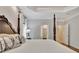 Elegant main bedroom with a four-poster bed and ensuite bathroom access at 104 Hidden Springs Ln, Peachtree City, GA 30269