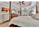 Spacious main bedroom with a four-poster bed, ceiling fan and plenty of natural light at 104 Hidden Springs Ln, Peachtree City, GA 30269