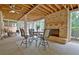 Covered patio features a stone fireplace, ceiling fans, and outdoor seating area at 104 Hidden Springs Ln, Peachtree City, GA 30269