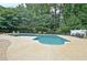 Backyard showcases a sparkling pool with a diving board, surrounded by a spacious deck for lounging and entertaining at 104 Hidden Springs Ln, Peachtree City, GA 30269