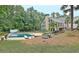 Inviting backyard oasis featuring a sparkling pool, lush landscaping, and charming outdoor living space at 104 Hidden Springs Ln, Peachtree City, GA 30269