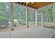 Enclosed porch offers a relaxing view of the manicured backyard and mature trees at 104 Hidden Springs Ln, Peachtree City, GA 30269