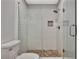Modern tiled shower with glass doors and pebble tile flooring at 104 Hidden Springs Ln, Peachtree City, GA 30269