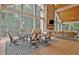Bright sunroom offers a dining area and living space with vaulted ceiling, large windows and wood-look floors at 104 Hidden Springs Ln, Peachtree City, GA 30269