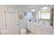 A modern bathroom featuring double sinks, a large mirror, and neutral paint at 2757 Malton Way, Loganville, GA 30052
