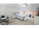 Bedroom with ceiling fan, exercise bike, queen bed, and a seating area at 2757 Malton Way, Loganville, GA 30052