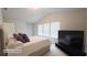 Bedroom featuring a bed, carpet, a TV, and natural light from a window at 2757 Malton Way, Loganville, GA 30052