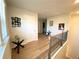 Upstairs hallway featuring wood floors, Gathering photos, and modern staircase at 2757 Malton Way, Loganville, GA 30052