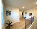 Hallway with wood floors, decor and staircase with railing at 2757 Malton Way, Loganville, GA 30052