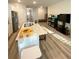 Open kitchen and living area with a central island, modern appliances, and plenty of space at 2757 Malton Way, Loganville, GA 30052