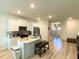 Bright kitchen features a central island and flows seamlessly into other living spaces at 2757 Malton Way, Loganville, GA 30052